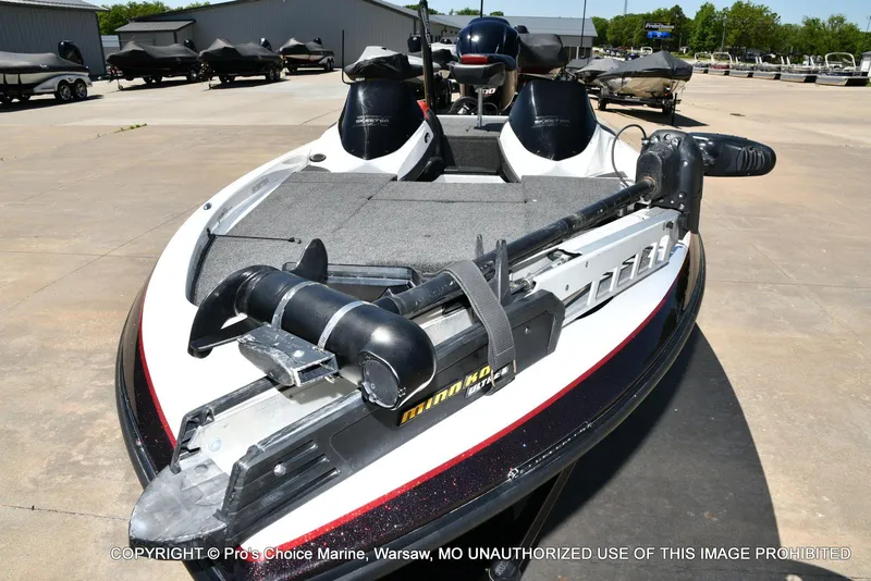 Slide: The Image of 2013 Skeeter ZX200 boat with trolling motor in a marina setting. - 28