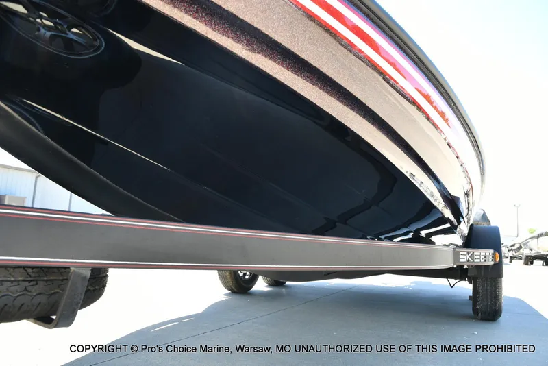 Slide: The Image of 2013 Skeeter ZX200 boat on trailer, close-up view of hull and wheels. - 31