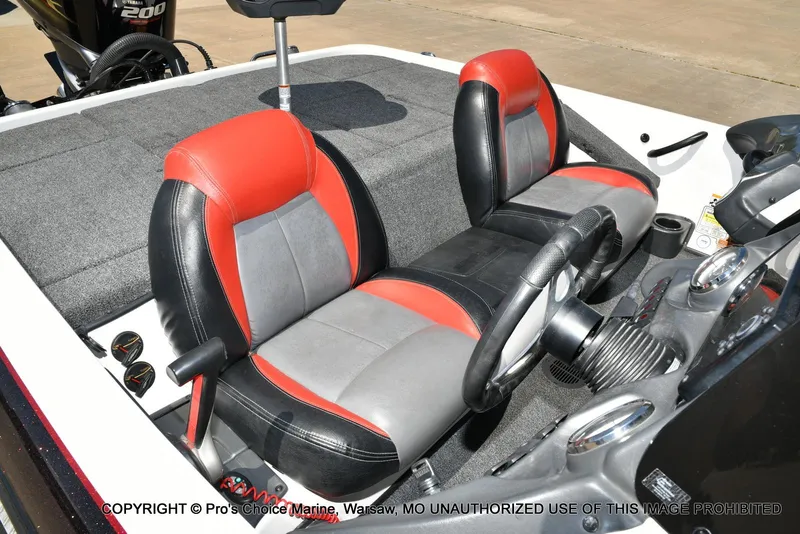 Slide: The Image of 2013 Skeeter ZX200 boat interior with red and gray seats, steering wheel, and dashboard. - 33