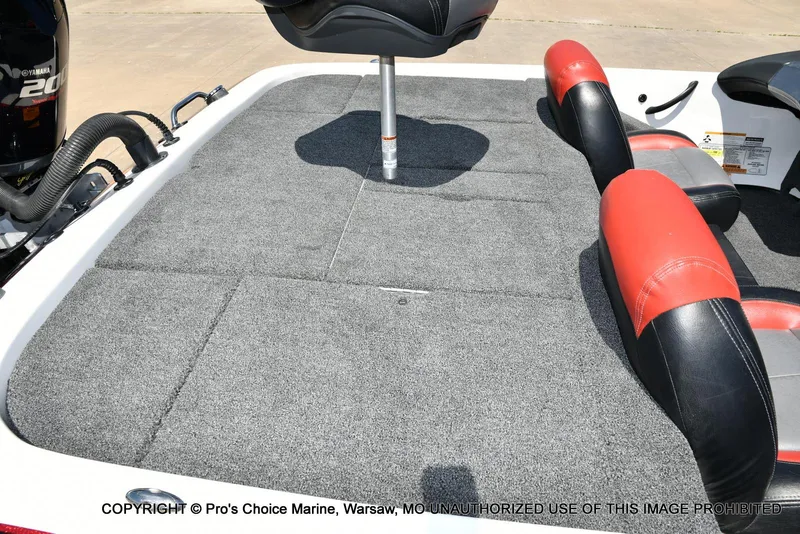 Slide: The Image of 2013 Skeeter ZX200 boat interior with carpeted deck and red-black seating. - 34