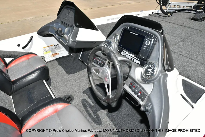 Slide: The Image of 2013 Skeeter ZX200 boat cockpit with steering wheel and control panel. - 35