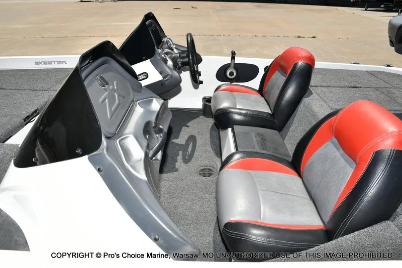 Slide: The Image of 2013 Skeeter ZX200 boat interior with red and gray seating, steering console, and carpeted flooring. - 37