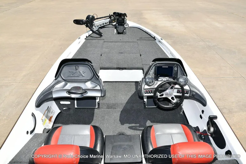 Slide: The Image of 2013 Skeeter ZX200 boat interior with steering wheel, seats, and control panel. - 38