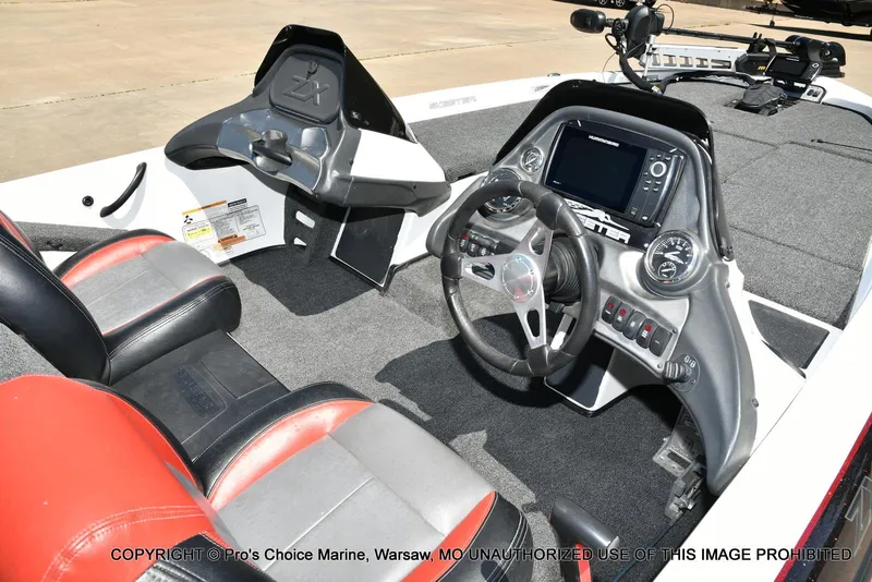 Slide: The Image of 2013 Skeeter ZX200 boat interior with steering wheel, dashboard, and dual seats. - 4