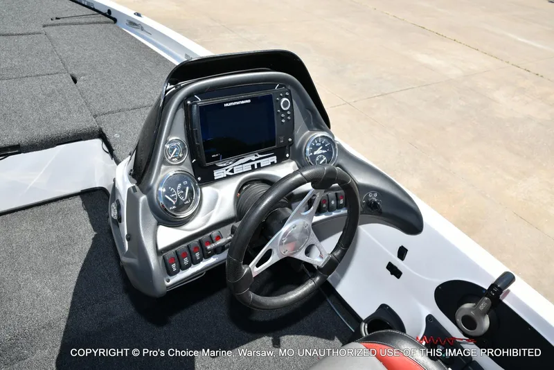 Slide: The Image of 2013 Skeeter ZX200 boat dashboard with steering wheel and electronic display. - 40