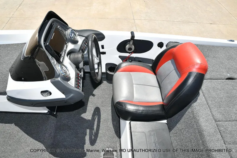 Slide: The Image of 2013 Skeeter ZX200 boat cockpit with steering wheel and red-gray seat. - 41