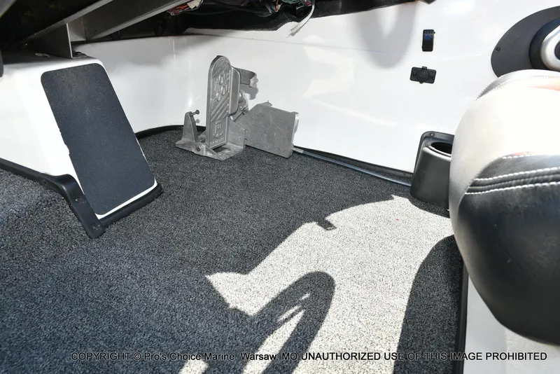 Slide: The Image of Interior of a 2013 Skeeter ZX200 boat showing foot pedal and carpeted flooring. - 42