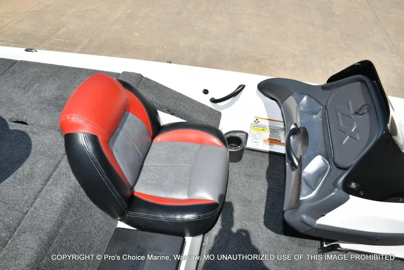 Slide: The Image of 2013 Skeeter ZX200 boat seat with red and gray upholstery, featuring a console and storage compartment. - 44