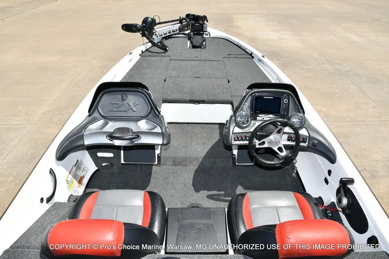 Slide: The Image of 2013 Skeeter ZX200 boat interior with dual seats, steering wheel, and control panel. - 6