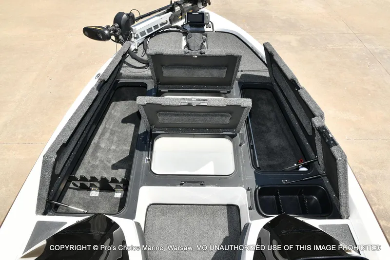 Slide: The Image of 2013 Skeeter ZX200 boat interior with open storage compartments and fishing equipment. - 7