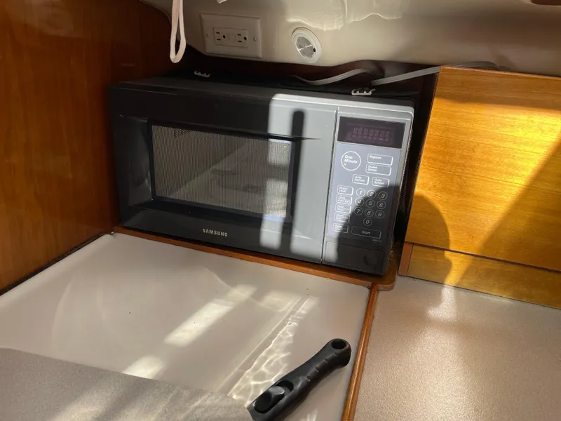 Slide: The Image of Microwave in Beneteau Oceanis 321 yacht kitchen, 2000 model, with wooden cabinetry. - 10
