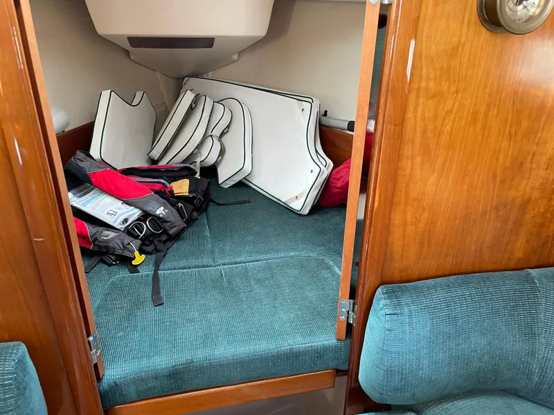 Slide: The Image of Cozy cabin interior of 2000 Beneteau Oceanis 321 sailboat with cushions and gear. - 19