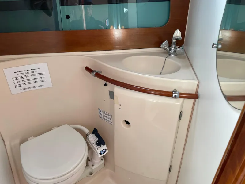 Slide: The Image of Bathroom interior of 2000 Beneteau Oceanis 321 sailboat, featuring toilet and sink. - 21