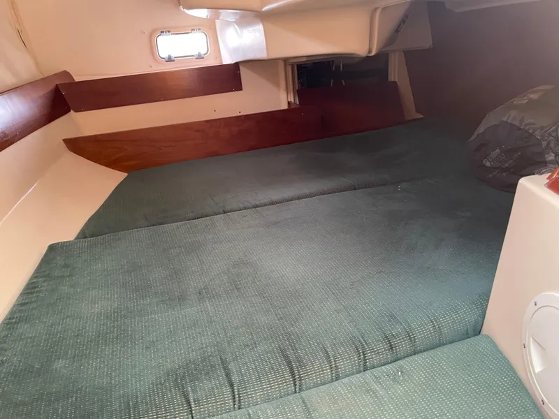 Slide: The Image of Cozy cabin interior of 2000 Beneteau Oceanis 321 sailboat with green upholstery. - 23