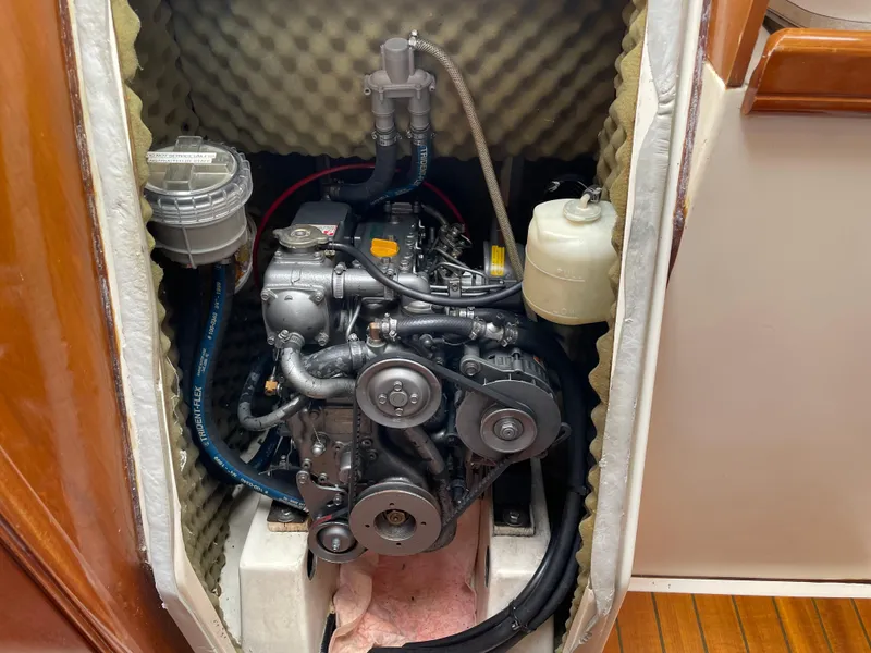 Slide: The Image of Engine compartment of a 2000 Beneteau Oceanis 321 sailboat, showcasing mechanical components. - 24