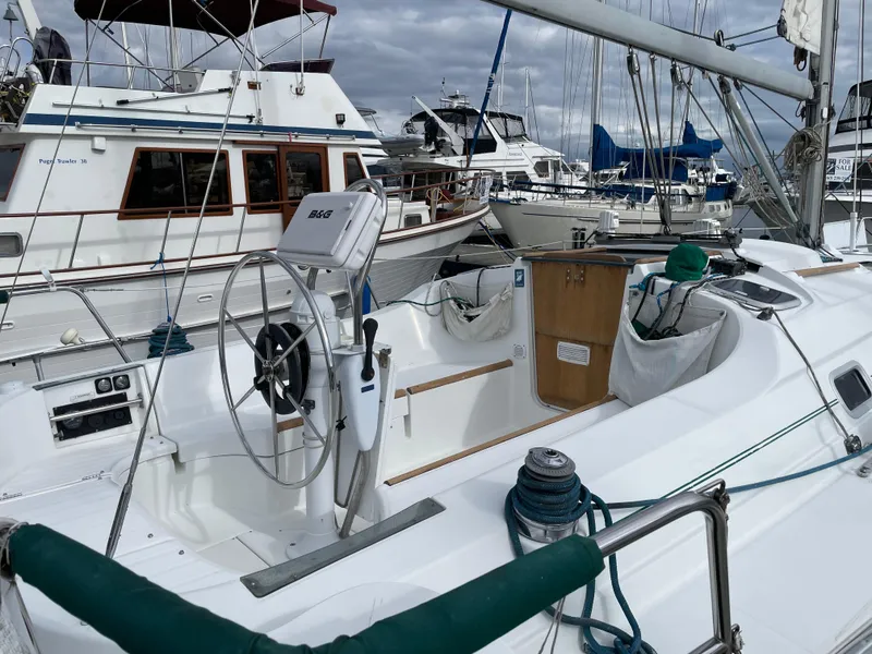 Slide: The Image of Beneteau Oceanis 321 sailboat cockpit, 2000 model, docked at marina with other boats. - 3