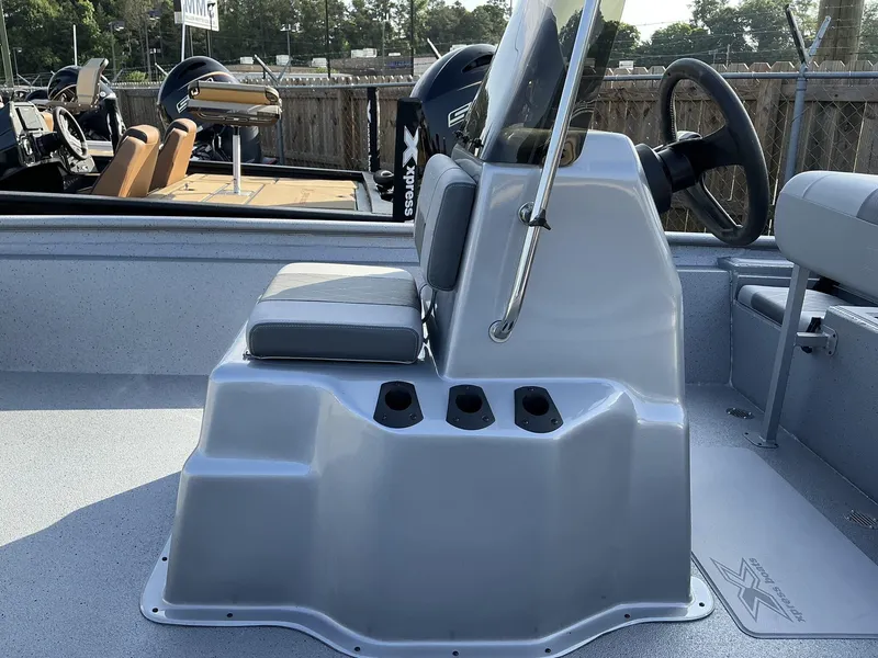 Slide: The Image of 2025 Xpress Xplorer Series XP20CC boat console with seating and steering wheel. - 4