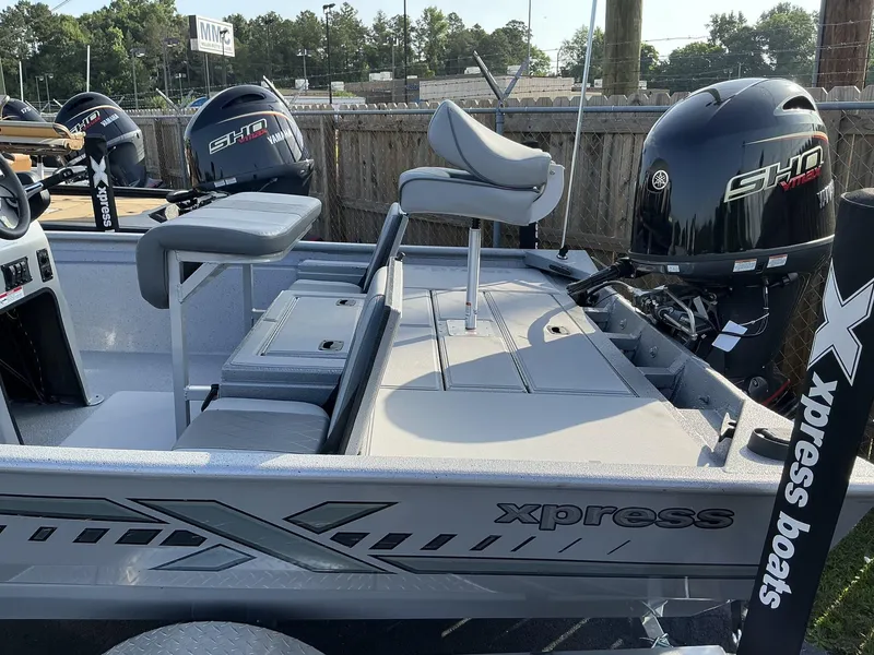 Slide: The Image of 2025 Xpress Xplorer Series XP20CC boat with Yamaha outboard engines, parked outdoors. - 8