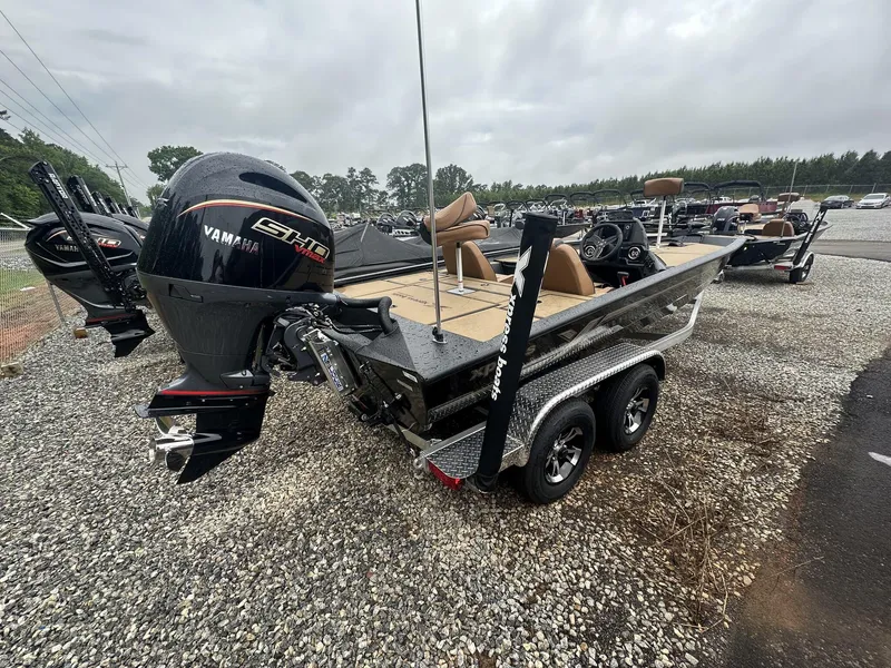 Slide: The Image of 2025 Xpress Hyper-Lift Bass Series boat with Yamaha engine on a trailer. - 4