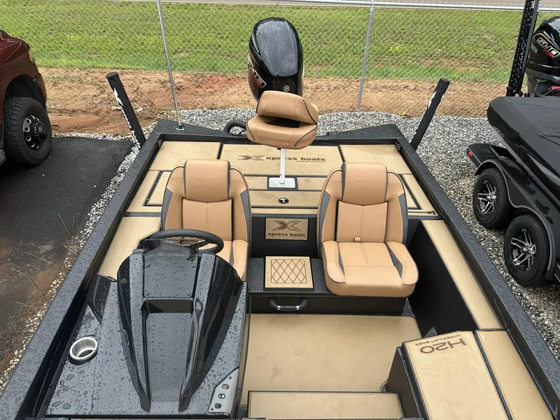 Slide: The Image of 2025 Xpress Hyper-Lift Bass Series boat with tan seats and sleek design. - 6