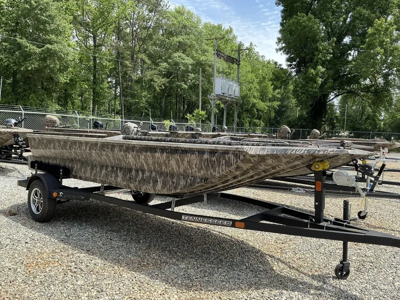 Slide: The Image of 2025 Reaper Boats 656 on trailer, camo design, parked outdoors. - 1