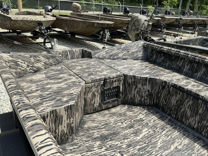 Slide: The Image of 2025 Reaper Boats 656 with camouflage design, parked on gravel lot. - 3