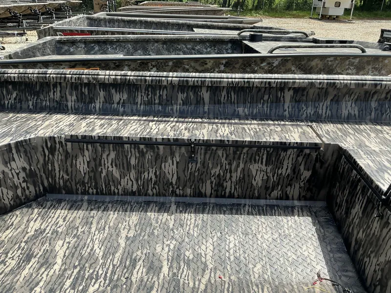 Slide: The Image of 2025 Reaper Boats 656 with camouflage pattern, parked outdoors. - 7