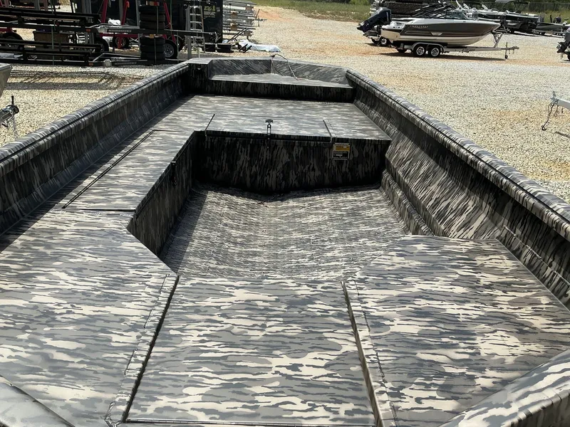 Slide: The Image of 2025 Reaper Boats 656 with camouflage design, displayed outdoors on gravel. - 5