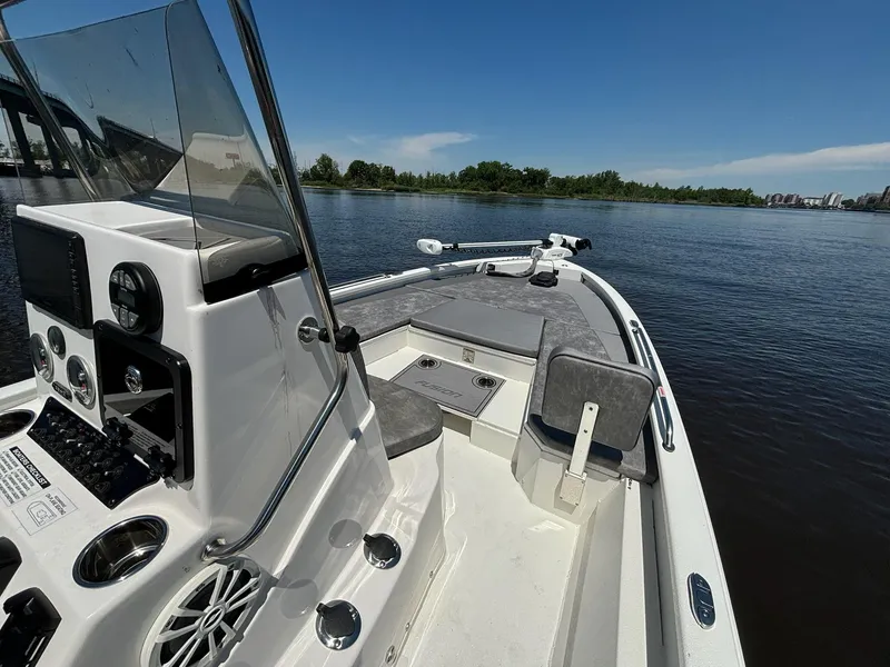 Slide: The Image of 2023 Avid 21 Fusion boat on calm water, featuring a sleek console and spacious seating. - 4
