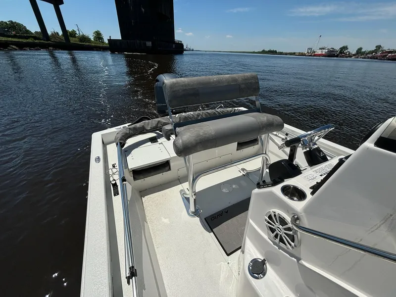 Slide: The Image of 2023 Avid 21 Fusion boat on calm water near a bridge, featuring a sleek interior. - 6
