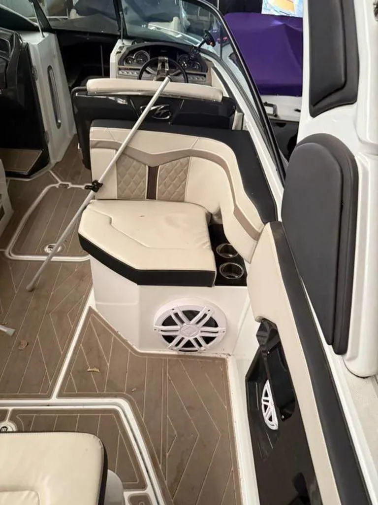 Slide: The Image of 2023 Monterey 258SS boat interior with beige seating and modern dashboard. - 5