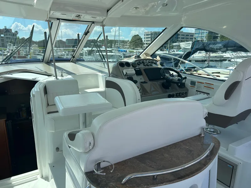 Slide: The Image of 2009 Cruisers Yachts 390 Sports Coupe cockpit with modern helm and seating in marina setting. - 21
