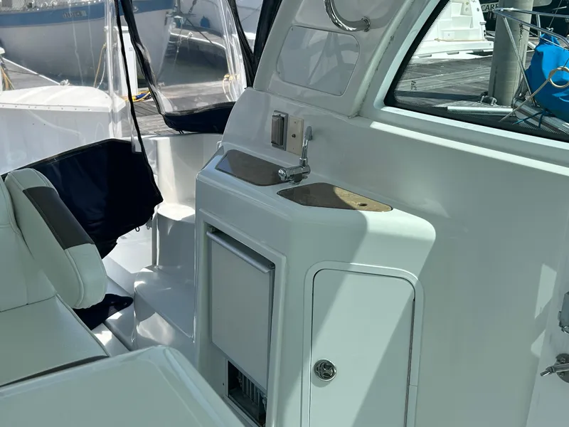 Slide: The Image of 2009 Cruisers Yachts 390 Sports Coupe interior with sink and seating area. - 29