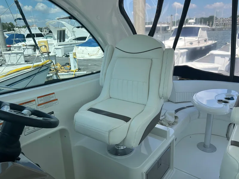 Slide: The Image of 2009 Cruisers Yachts 390 Sports Coupe interior with helm seat and marina view. - 33
