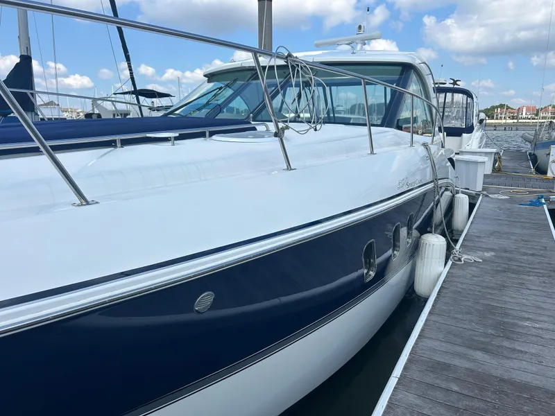 Slide: The Image of 2009 Cruisers Yachts 390 Sports Coupe docked at marina under blue sky. - 13