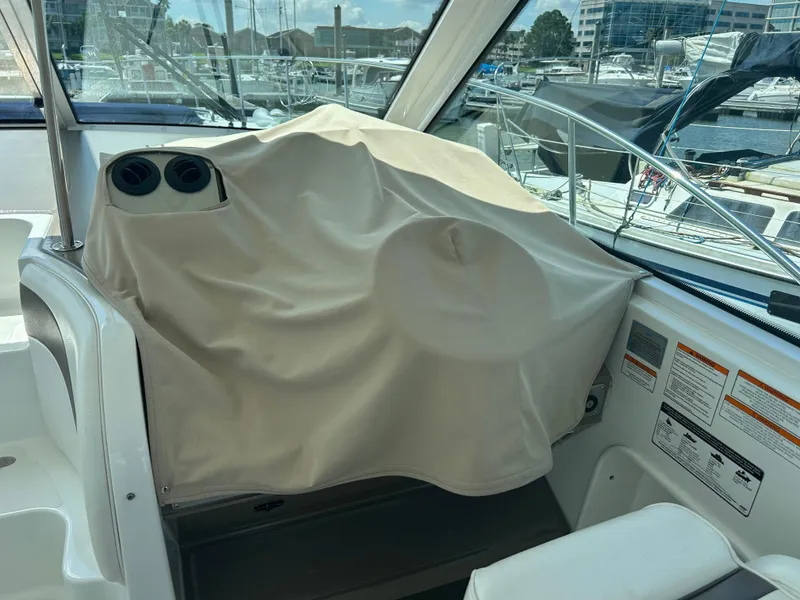 Slide: The Image of 2009 Cruisers Yachts 390 Sports Coupe helm covered, docked at marina. - 17