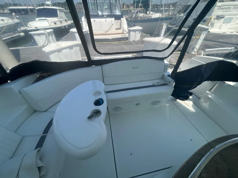 Slide: The Image of 2009 Cruisers Yachts 390 Sports Coupe interior with seating and table, docked at marina. - 23