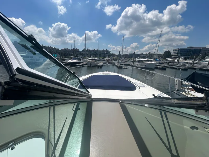 Slide: The Image of 2009 Cruisers Yachts 390 Sports Coupe docked in a sunny marina. - 31