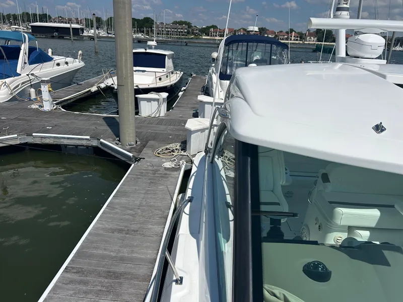 Slide: The Image of 2009 Cruisers Yachts 390 Sports Coupe docked at marina with other boats. - 39