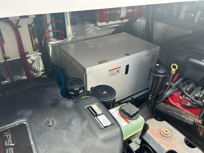 Slide: The Image of Engine compartment of 2009 Cruisers Yachts 390 Sports Coupe, showcasing generator and components. - 47