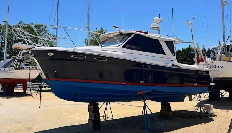 Slide: The Image of 2013 Cutwater C-28 boat on stands, blue hull, outdoor storage. - 0