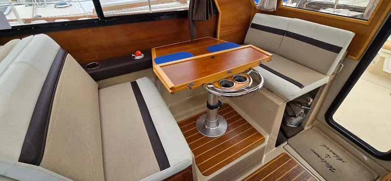 Slide: The Image of Interior of 2013 Cutwater C-28 boat with seating and wooden table. - 12