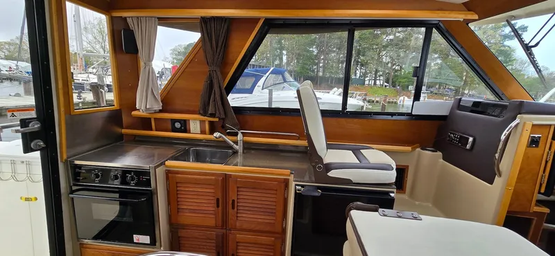 Slide: The Image of Interior of 2013 Cutwater C-28 boat with kitchen and seating area. - 14