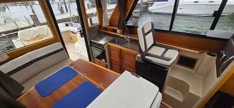 Slide: The Image of Interior of 2013 Cutwater C-28 boat with seating, table, and kitchenette. - 15