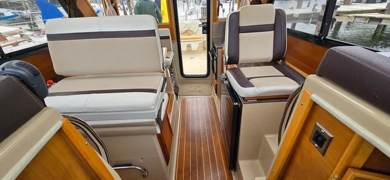 Slide: The Image of Interior of a 2013 Cutwater C-28 boat with beige and brown seating. - 17