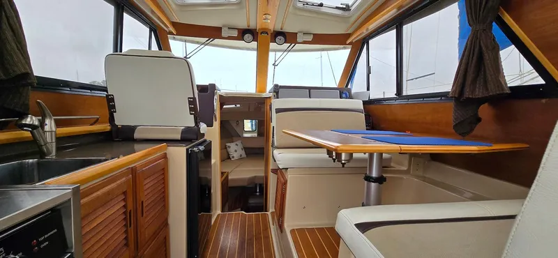 Slide: The Image of Interior of 2013 Cutwater C-28 boat with wood accents and seating area. - 19