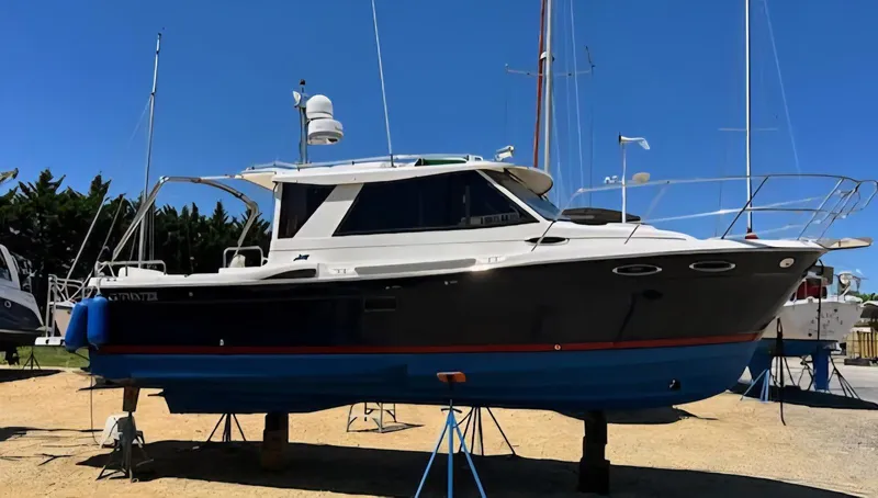Slide: The Image of 2013 Cutwater C-28 boat on stands, displayed outdoors under clear blue sky. - 2