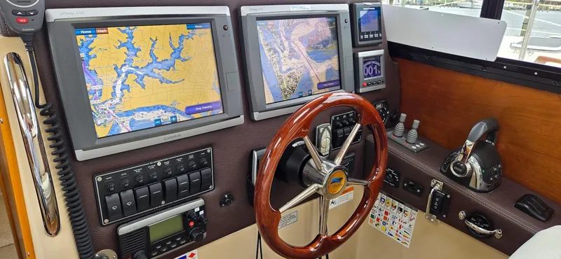 Slide: The Image of 2013 Cutwater C-28 helm with dual navigation screens and wooden steering wheel. - 23