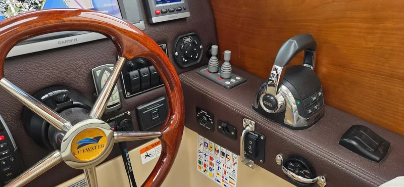Slide: The Image of 2013 Cutwater C-28 helm with steering wheel, controls, and navigation equipment. - 24