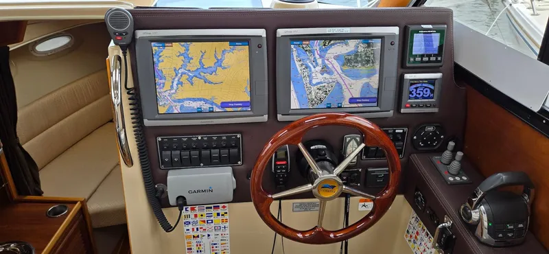 Slide: The Image of 2013 Cutwater C-28 helm with dual navigation screens and wooden steering wheel. - 25